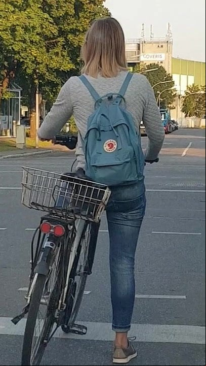 Candid ass in jeans - young girl riding bike